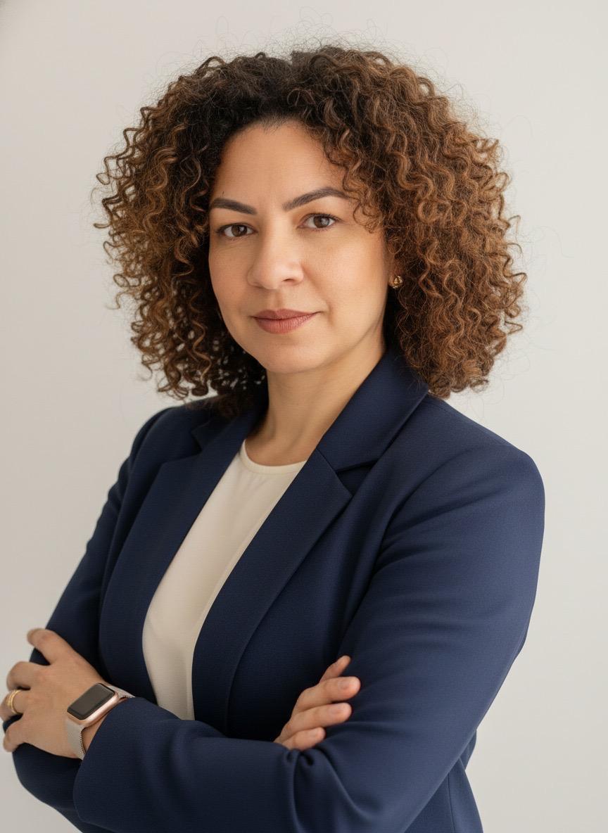 Marli Rocha, estrategista digital, de blazer azul-marinho e braços cruzados, olhando para a câmera
